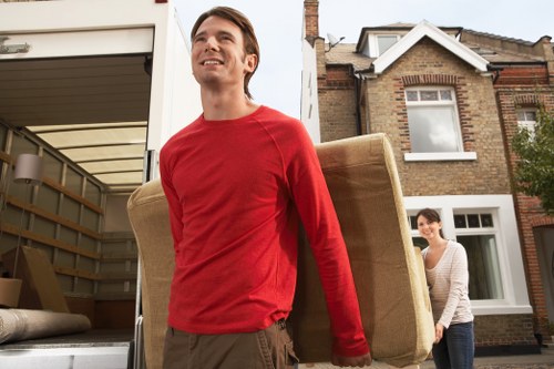Professional movers carefully handling furniture